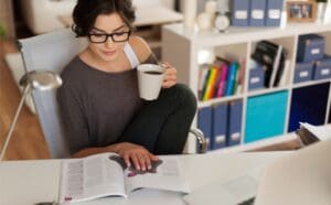 The Value of Printing in the Age of Digital - Woman drinking coffee and reading